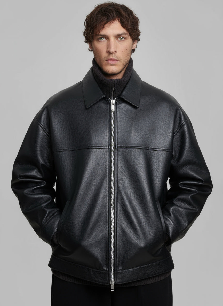 Man wearing a black leather jacket against a gray background